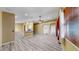 Bright living room featuring wood floors, a ceiling fan, and views of the adjacent breakfast bar at 8603 Sandy Plains Dr, Riverview, FL 33578