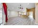 Spacious living room with wood floors, ceiling fan, and an open layout to the kitchen area at 8603 Sandy Plains Dr, Riverview, FL 33578