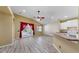 Open concept living room featuring wood floors, ceiling fan, and convenient access to the kitchen at 8603 Sandy Plains Dr, Riverview, FL 33578