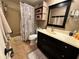 Bathroom featuring a vanity with a dark wood finish and a shower/tub combo with a floral curtain at 8651 10Th N St # 236, St Petersburg, FL 33702