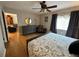 Spacious bedroom with hardwood floors, a ceiling fan and a sitting area at 8651 10Th N St # 236, St Petersburg, FL 33702