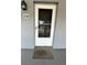 A welcoming front door with a screen door and a 'welcome' mat on a covered porch at 8651 10Th N St # 236, St Petersburg, FL 33702