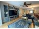 Inviting living room featuring a large blue rug, comfortable seating, and a custom built-in entertainment center at 8651 10Th N St # 236, St Petersburg, FL 33702