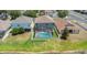 Aerial view of a backyard with a screened-in pool and fence, offering privacy at 10007 Coldwater Loop, Land O Lakes, FL 34638