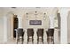 Elegant home bar with leather chairs, marble countertop, and pendant lighting at 102 Adriatic Ave, Tampa, FL 33606
