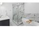 Contemporary bathroom boasts a freestanding tub and glass shower, accented with marble-look tiling at 102 Adriatic Ave, Tampa, FL 33606