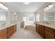 Bright bathroom featuring double sinks, walk-in shower, and soaking tub at 102 Adriatic Ave, Tampa, FL 33606