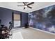 Spacious bedroom with a bold galaxy mural, comfortable computer chair, and serene dark blue walls at 102 Adriatic Ave, Tampa, FL 33606