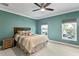 Comfortable bedroom with ceiling fan, natural light, and a beautifully dressed queen-sized bed at 102 Adriatic Ave, Tampa, FL 33606