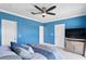 Inviting bedroom features bright blue walls, a ceiling fan, and a plush bed for restful nights at 102 Adriatic Ave, Tampa, FL 33606