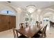 Elegant dining room with marble floors, decorative columns, and a crystal chandelier at 102 Adriatic Ave, Tampa, FL 33606