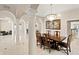 Grand dining room with decorative columns, elegant chandelier, and wood table at 102 Adriatic Ave, Tampa, FL 33606
