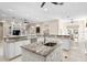 Spacious kitchen with granite countertops, white cabinets, and a large island at 102 Adriatic Ave, Tampa, FL 33606
