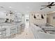 Open-concept space with kitchen island, stainless appliances, hardwood floors, and comfortable living area at 102 Adriatic Ave, Tampa, FL 33606
