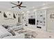Living room with custom built-ins, neutral decor, ceiling fan, and stylish furniture at 102 Adriatic Ave, Tampa, FL 33606