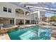 Spacious pool area featuring a stone spa and a large backyard with patio at 102 Adriatic Ave, Tampa, FL 33606