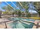 Beautiful screened in pool featuring a spa and lush landscaping at 102 Adriatic Ave, Tampa, FL 33606
