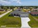 High aerial view showcasing the single-Gathering home with its front lawn, driveway, and surrounding neighborhood at 10493 Grail Ave, Englewood, FL 34224