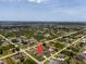Birds eye view of the property in a residential neighborhood, with trees, homes, and other natural features at 10493 Grail Ave, Englewood, FL 34224