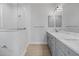 Bathroom featuring double sinks, gray cabinets, and a glass-enclosed shower at 10493 Grail Ave, Englewood, FL 34224
