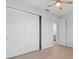 Bright bedroom featuring wood-look tile flooring and a closet with sliding doors at 10493 Grail Ave, Englewood, FL 34224