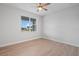 Light-filled bedroom with wood-look tile flooring and a bright window at 10493 Grail Ave, Englewood, FL 34224