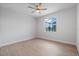 Bright bedroom featuring wood-look tile flooring, a ceiling fan, and a view to the outside at 10493 Grail Ave, Englewood, FL 34224