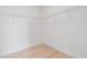 Walk-in closet with built-in shelving and wood-look tile flooring at 10493 Grail Ave, Englewood, FL 34224