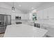 Spacious kitchen featuring white cabinets, stainless steel appliances, and a large center island at 10493 Grail Ave, Englewood, FL 34224