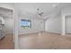 Living room with a large window, light wood-look flooring, and view of entryway at 10493 Grail Ave, Englewood, FL 34224