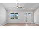 Bright living room with a large window and a light wood-look flooring at 10493 Grail Ave, Englewood, FL 34224
