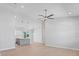 Bright, open-concept living room with recessed lighting, ceiling fan, and kitchen view at 10493 Grail Ave, Englewood, FL 34224