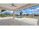 Screened in outdoor pool and patio area with open space and a view of surrounding homes at 10493 Grail Ave, Englewood, FL 34224