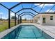 Backyard pool and patio surrounded by a screened-in enclosure, perfect for outdoor relaxation and swimming at 10493 Grail Ave, Englewood, FL 34224