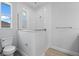 Bright bathroom featuring a glass-enclosed shower, toilet, and a window at 10493 Grail Ave, Englewood, FL 34224
