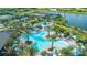 Aerial view showcases a resort-style pool area with multiple pools, seating, and palm trees throughout the community at 10816 Wendover Dr, Palmetto, FL 34221