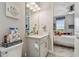 Bright bathroom with vanity, mirror and view into the bedroom with natural light coming through the window at 10816 Wendover Dr, Palmetto, FL 34221
