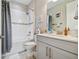 Well-lit bathroom with a tub-shower combo, gray vanity, and soft gray accents for a calming experience at 10816 Wendover Dr, Palmetto, FL 34221
