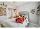 Cozy bedroom view with stuffed animals on the bed, adjacent bathroom access and inviting decor at 10816 Wendover Dr, Palmetto, FL 34221