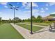 Well-maintained bocce ball courts feature manicured landscaping, shaded seating, and convenient lighting fixtures at 10816 Wendover Dr, Palmetto, FL 34221
