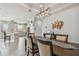 Beautiful dining room showcasing modern lighting adjacent to an open kitchen concept at 10816 Wendover Dr, Palmetto, FL 34221