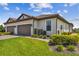Beautiful home featuring a three car garage, paver driveway, and mature landscaping at 10816 Wendover Dr, Palmetto, FL 34221