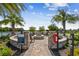 Community fire pit area features a stone firepit, seating, and views of the lake, perfect for gatherings at 10816 Wendover Dr, Palmetto, FL 34221