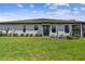 Charming one-story home with a well manicured lawn, tiled roof, and lush landscaping at 10816 Wendover Dr, Palmetto, FL 34221