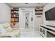 Cozy hallway area with a white chair, sleek console, wall decor, and an open doorway that expands the space at 10816 Wendover Dr, Palmetto, FL 34221