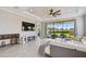Spacious living room with a ceiling fan, fireplace, and patio access at 10816 Wendover Dr, Palmetto, FL 34221