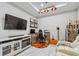 Well-lit office space features a modern desk, gaming setup, display shelves and a comfortable leather chair at 10816 Wendover Dr, Palmetto, FL 34221