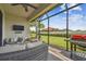 Outdoor living with screened patio with a grill, comfortable seating, and a tranquil backyard at 10816 Wendover Dr, Palmetto, FL 34221