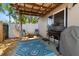 Inviting back patio featuring a grill, hammock, blue rug, and string lights, perfect for outdoor entertaining at 1108 16Th Nw Ave, Clearwater, FL 33756