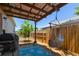 Inviting back patio featuring a grill, hammock, blue rug, and string lights, great for entertaining at 1108 16Th Nw Ave, Clearwater, FL 33756
